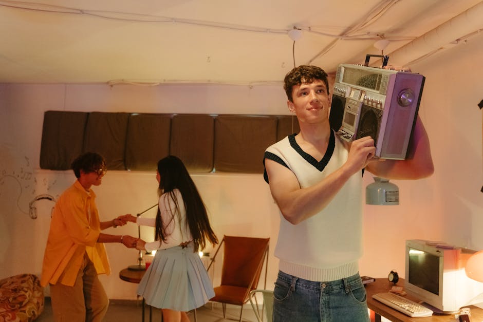 Three teenagers in a retro room enjoying music from a vintage boombox indoors.